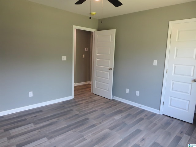 unfurnished room with baseboards, ceiling fan, and wood finished floors