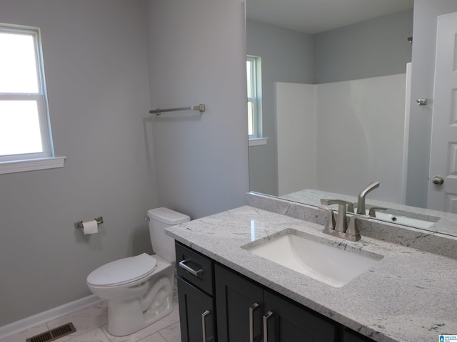 bathroom with visible vents, vanity, marble finish floor, toilet, and baseboards