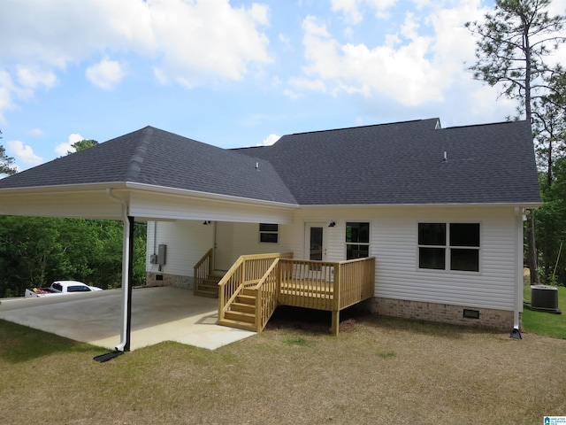 back of property featuring a shingled roof, central AC, an attached carport, crawl space, and a yard