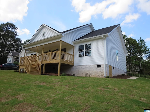 back of house with a lawn, crawl space, and stairs