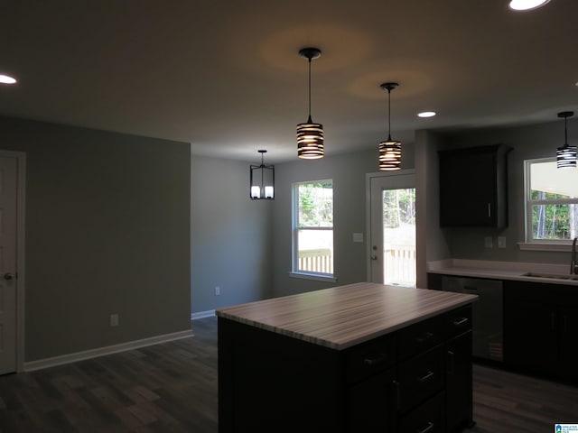 kitchen with a sink, black dishwasher, recessed lighting, and dark wood-type flooring