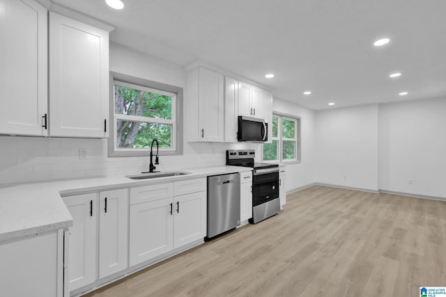 kitchen featuring recessed lighting, a sink, tasteful backsplash, and stainless steel appliances