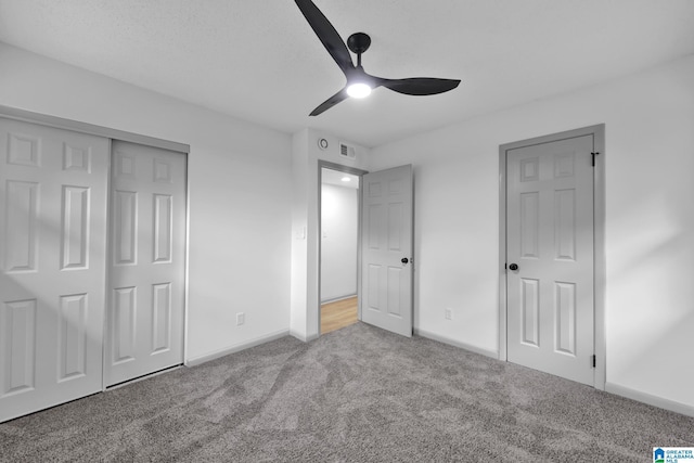 unfurnished bedroom with ceiling fan, visible vents, baseboards, a closet, and carpet flooring