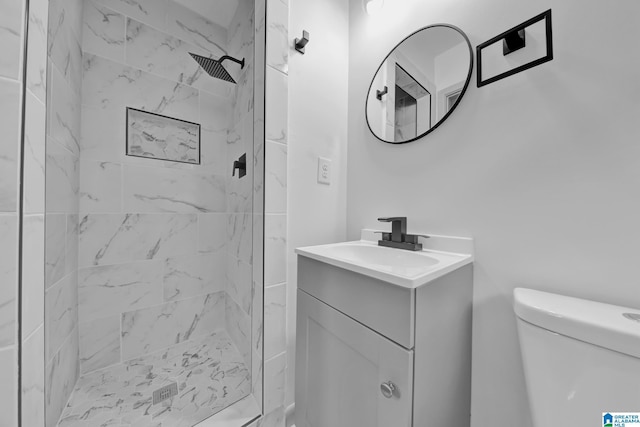 bathroom featuring vanity, toilet, and a shower stall