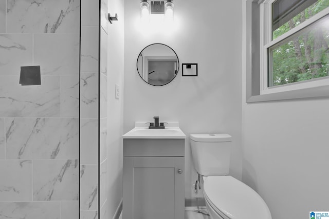 bathroom featuring vanity, marble finish floor, and toilet