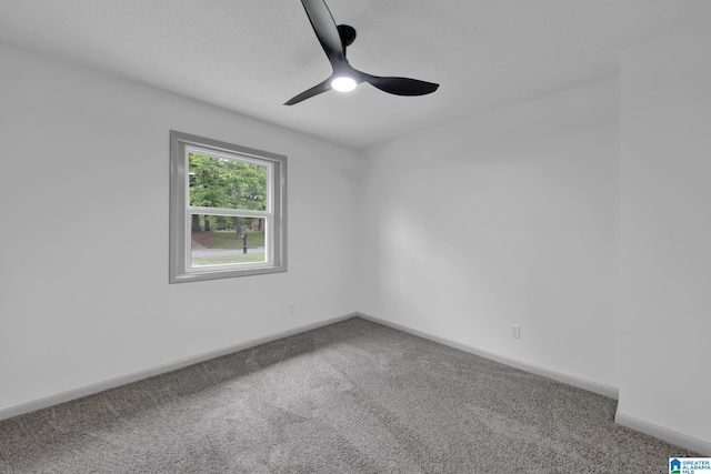 spare room featuring a ceiling fan, baseboards, and carpet