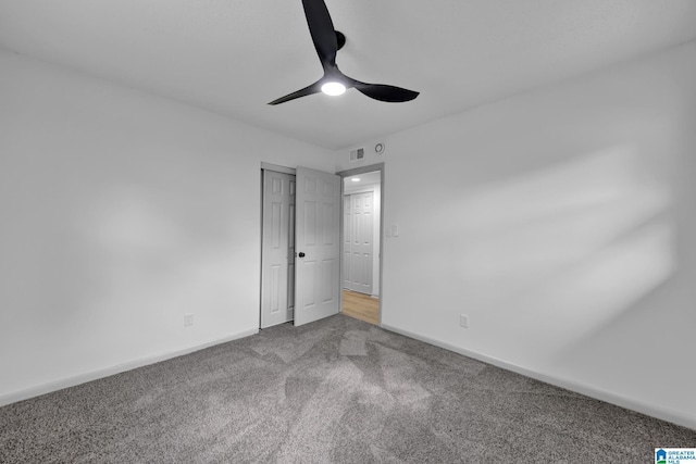 unfurnished bedroom with ceiling fan, visible vents, baseboards, a closet, and carpet