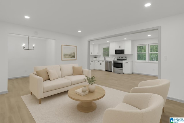 living area featuring recessed lighting, baseboards, light wood-type flooring, and a chandelier
