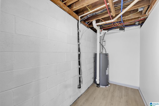 unfinished below grade area with light wood finished floors and electric water heater