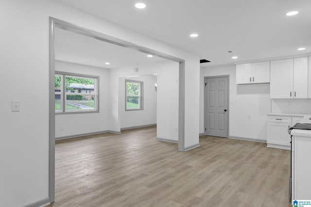 kitchen with light wood finished floors, light countertops, recessed lighting, baseboards, and white cabinetry
