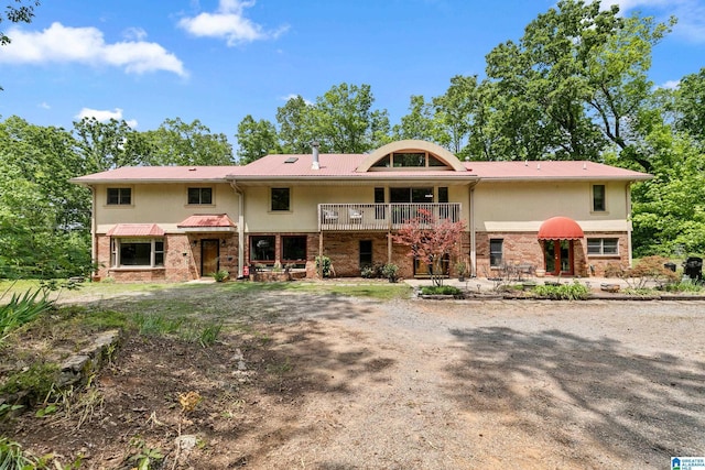 323 Taylor Rd, Remlap, AL 35133 - view of front of house with stucco siding, brick siding, and a balcony