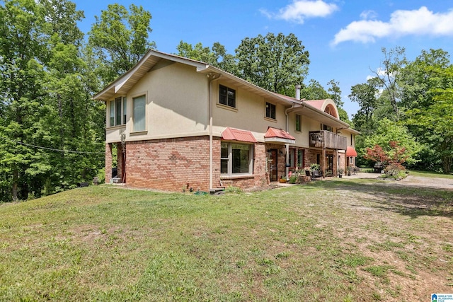 323 Taylor Rd, Remlap, AL 35133 - view of front of property with a balcony, stucco siding, brick siding, and a front yard
