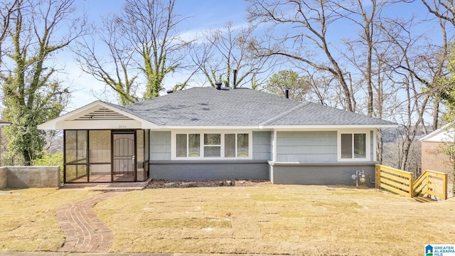 2636 20th Pl, Birmingham, AL 35208 - rear view of house featuring roof with shingles, a yard, and brick siding