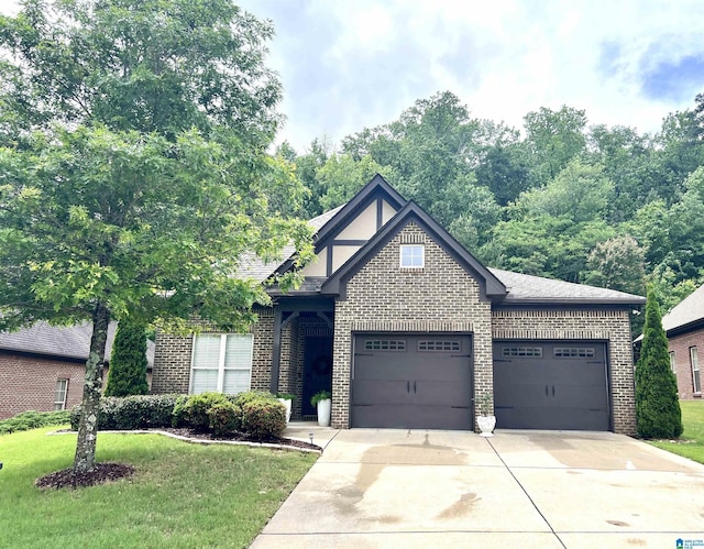 1204 Grants Way, Irondale, AL 35210 - view of front of house with a garage, brick siding, driveway, and a front lawn