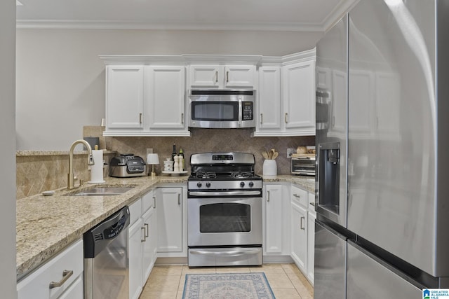 1204 Grants Way, Irondale, AL 35210 - kitchen with stainless steel appliances, a sink, white cabinetry, light stone countertops, and crown molding