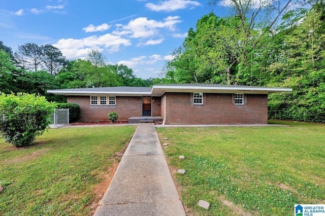 ranch-style home with brick siding and a front yard