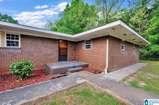 doorway to property featuring brick siding