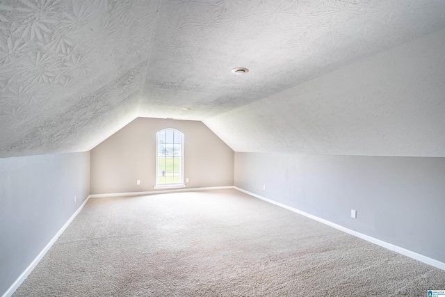 145 Cameron Ct, Alexandria, AL 36250 - additional living space with baseboards, carpet flooring, and vaulted ceiling