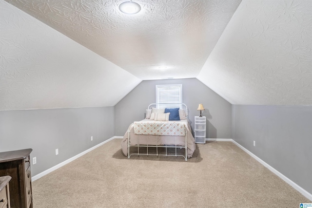 145 Cameron Ct, Alexandria, AL 36250 - carpeted bedroom featuring baseboards, vaulted ceiling, and a textured ceiling