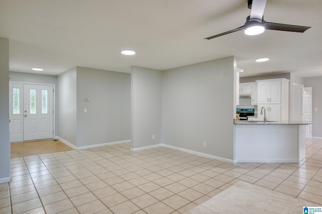 unfurnished living room featuring light tile patterned flooring, ceiling fan, a sink, recessed lighting, and baseboards