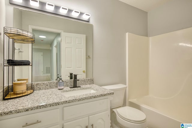 bathroom with toilet, visible vents, and vanity