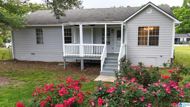 view of front of home with a shingled roof, a front lawn, covered porch, and crawl space