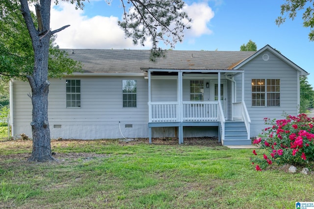 back of property featuring covered porch, crawl space, and a lawn
