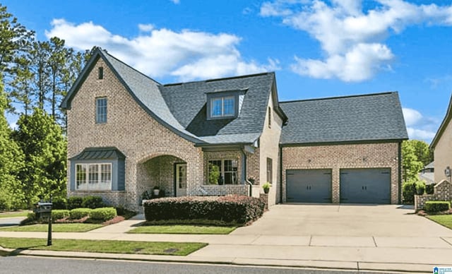 4000 Dunemere Ln, Hoover, AL 35226 - tudor-style house featuring brick siding, driveway, a garage, and roof with shingles