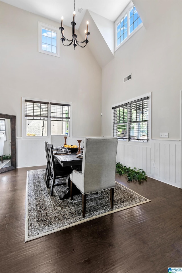 4000 Dunemere Ln, Hoover, AL 35226 - dining space with a chandelier, a high ceiling, a wainscoted wall, and wood finished floors
