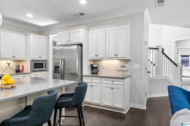 4000 Dunemere Ln, Hoover, AL 35226 - kitchen featuring stainless steel appliances, a breakfast bar area, dark wood-style floors, white cabinets, and recessed lighting