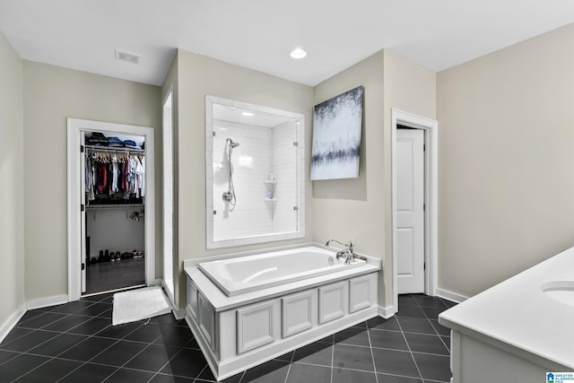 4000 Dunemere Ln, Hoover, AL 35226 - full bath featuring tile patterned floors, a bath, tiled shower, vanity, and a walk in closet