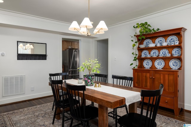 1305 31st St S Unit 202, Birmingham, AL 35205 - dining space with a chandelier, dark wood-style floors, and baseboards