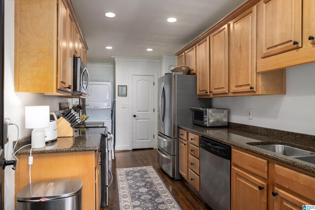 1305 31st St S Unit 202, Birmingham, AL 35205 - kitchen with stacked washer / dryer, stainless steel appliances, recessed lighting, dark wood-style floors, and dark stone countertops
