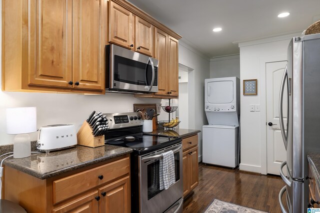 1305 31st St S Unit 202, Birmingham, AL 35205 - kitchen with stainless steel appliances, stacked washing machine and dryer, dark wood finished floors, crown molding, and recessed lighting