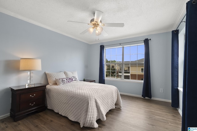 bedroom featuring ornamental molding, wood finished floors, baseboards, a textured ceiling, and a ceiling fan