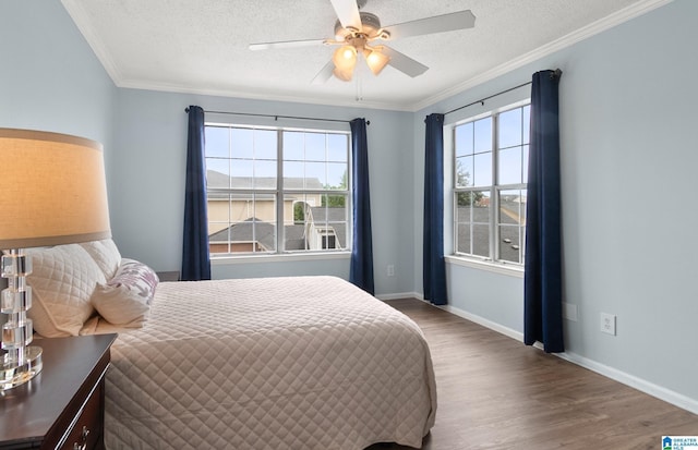 bedroom featuring crown molding, a textured ceiling, and wood finished floors