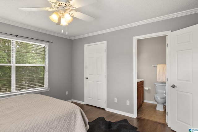 bedroom featuring ornamental molding, ensuite bathroom, dark wood-style floors, and a textured ceiling