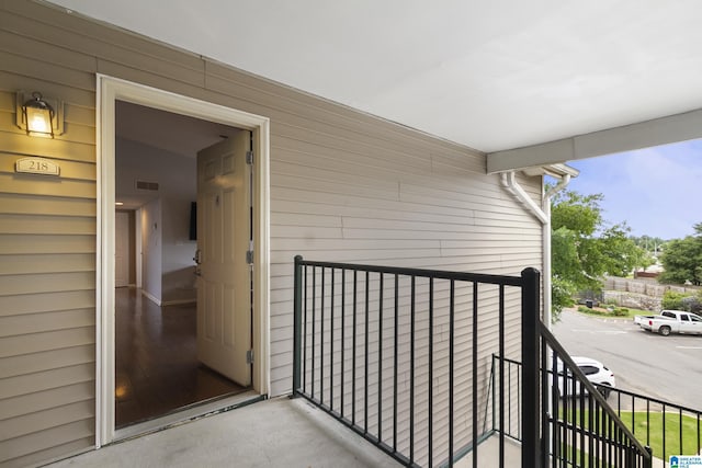view of exterior entry featuring a balcony
