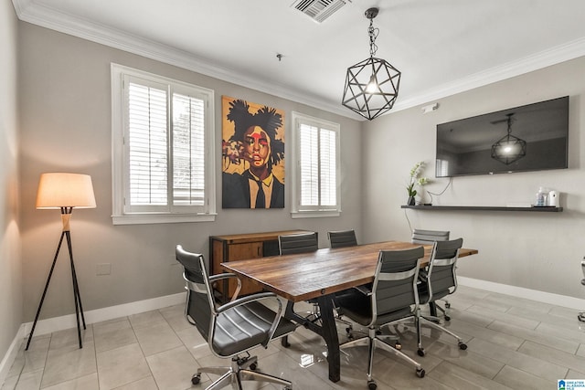 dining room with a healthy amount of sunlight, baseboards, crown molding, and visible vents