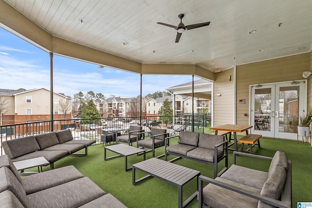 view of patio with french doors, an outdoor living space, and a residential view