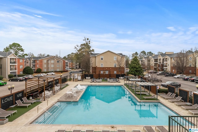 pool featuring a residential view, fence, and a patio