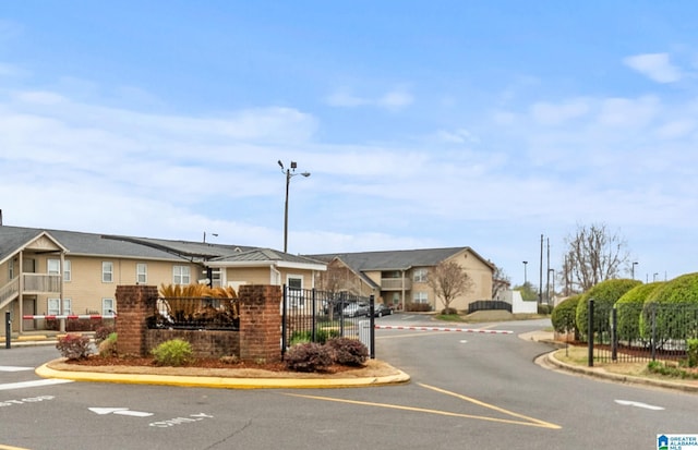 view of road with street lights, a residential view, and curbs