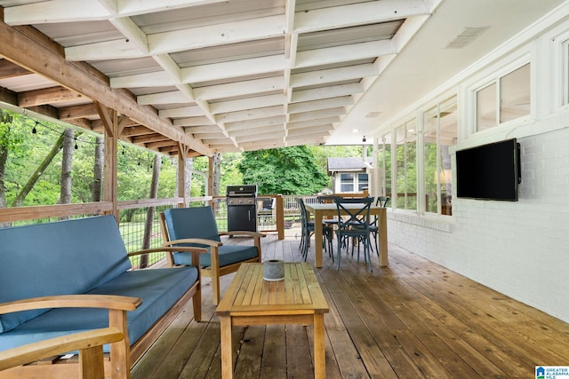 deck featuring visible vents, grilling area, an outdoor hangout area, and outdoor dining space