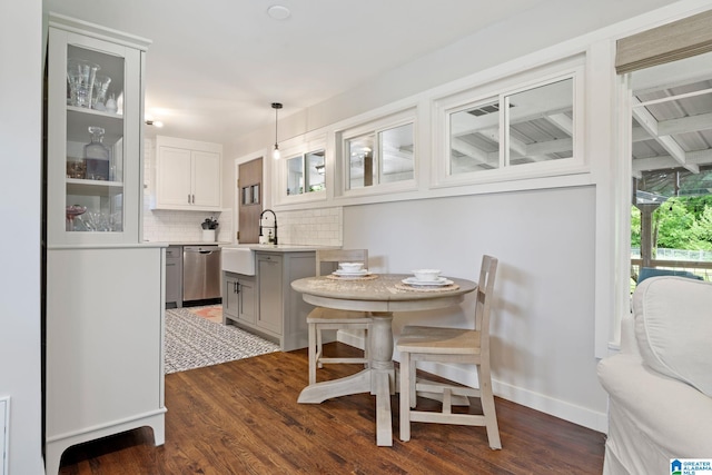 dining room featuring dark wood-style flooring and baseboards