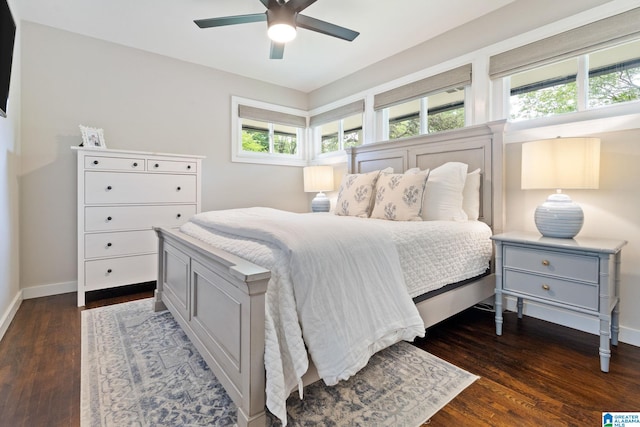 bedroom featuring baseboards, multiple windows, ceiling fan, and dark wood-type flooring