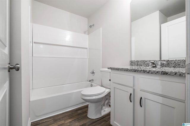 full bathroom featuring vanity, washtub / shower combination, wood finished floors, and toilet