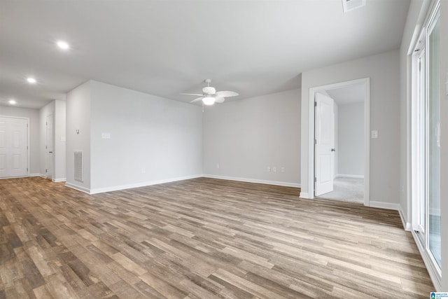 interior space with baseboards, recessed lighting, ceiling fan, and wood finished floors