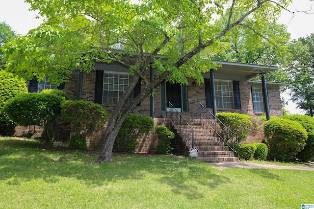view of front facade featuring a front yard and brick siding