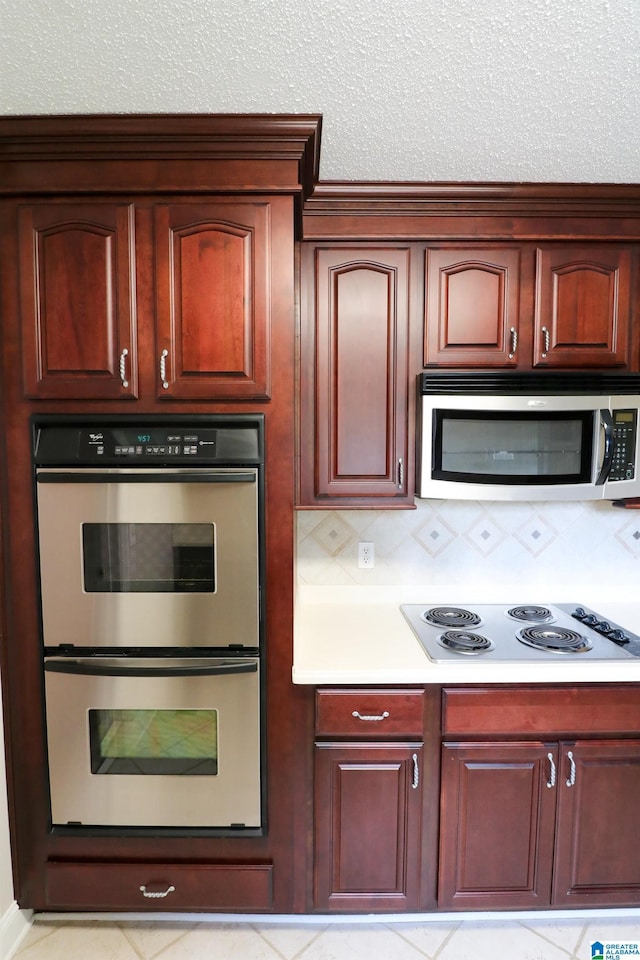kitchen with light countertops, stainless steel appliances, and tasteful backsplash