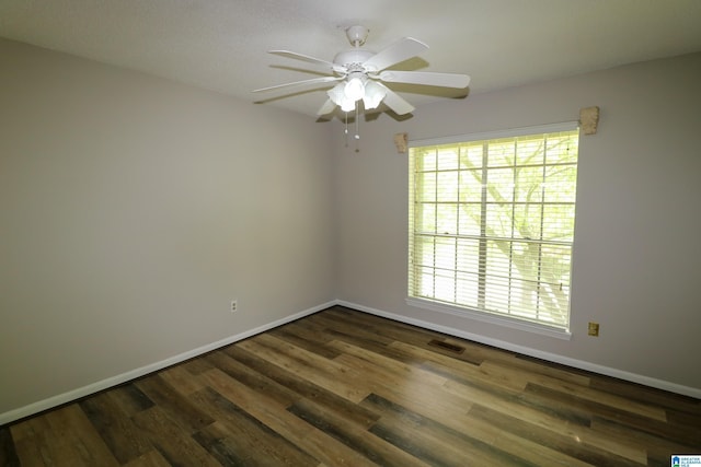 unfurnished room with baseboards, ceiling fan, visible vents, and wood finished floors